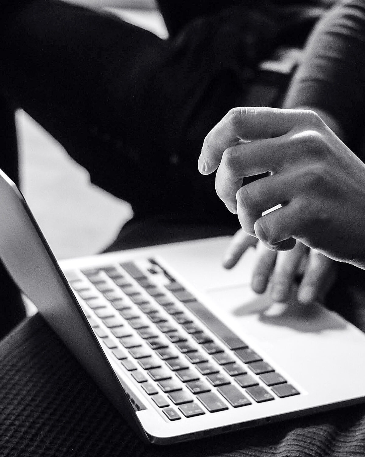 Laptop and working hands in grey tones